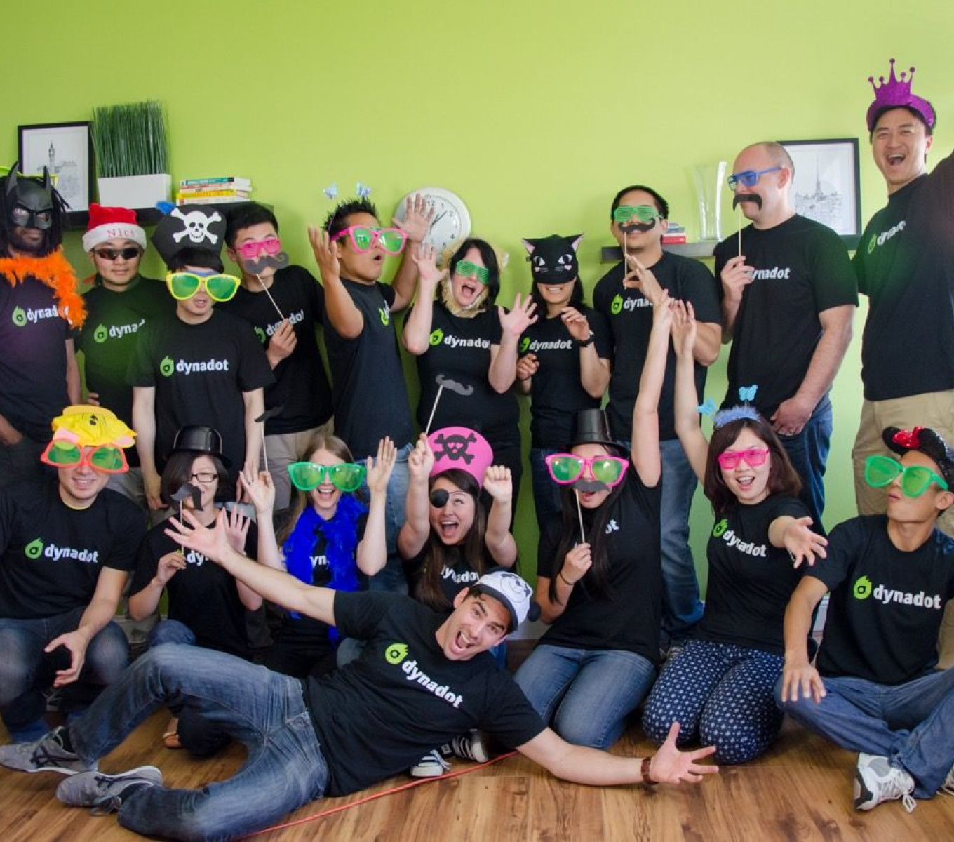 dynadot employees wearing dynadot t-shirts and fun costumes with big glasses and mustaches